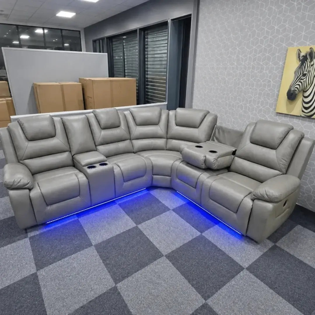Grey leather corner sofa with blue LED strip for a home cinema look